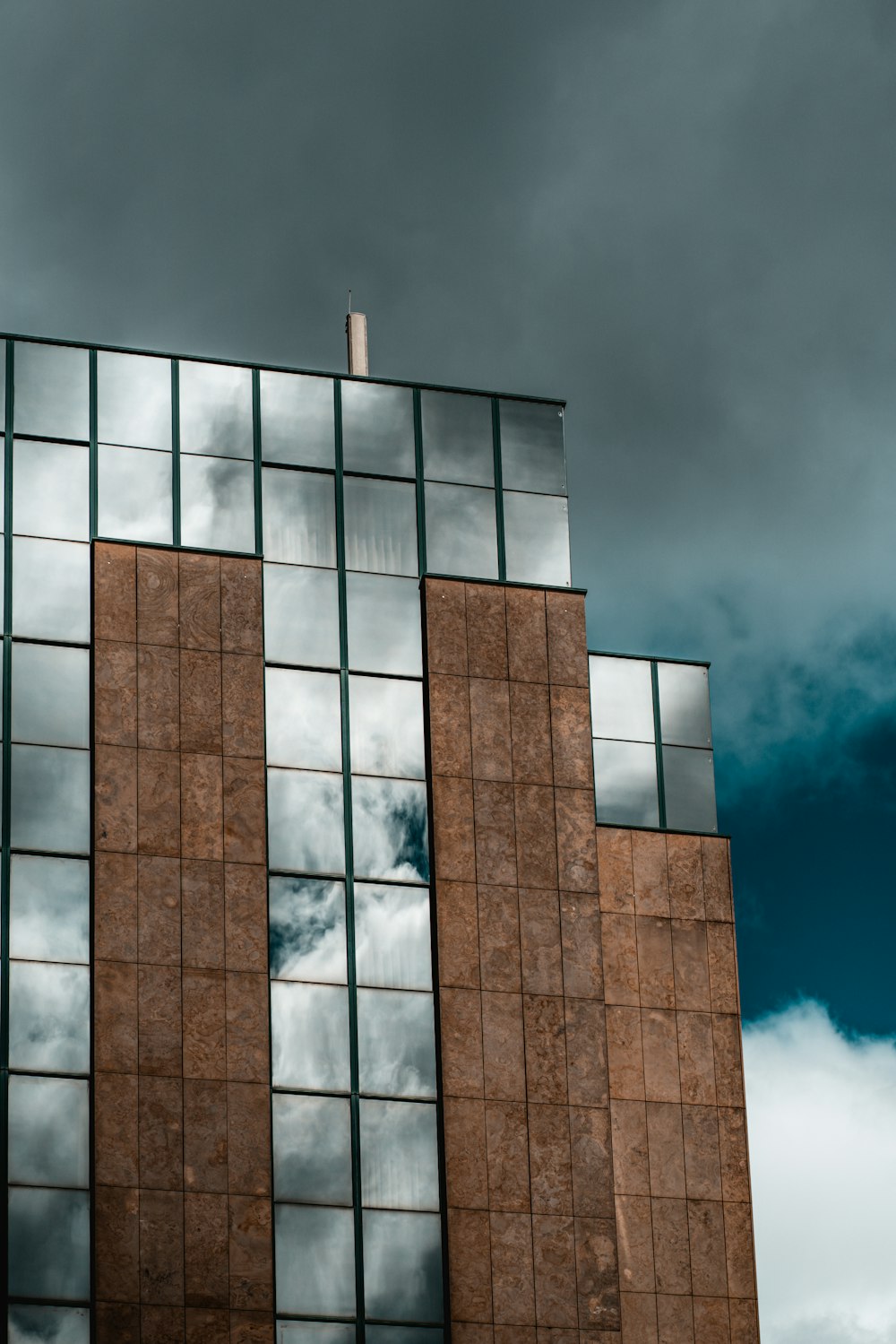 brown and gray concrete building under blue sky