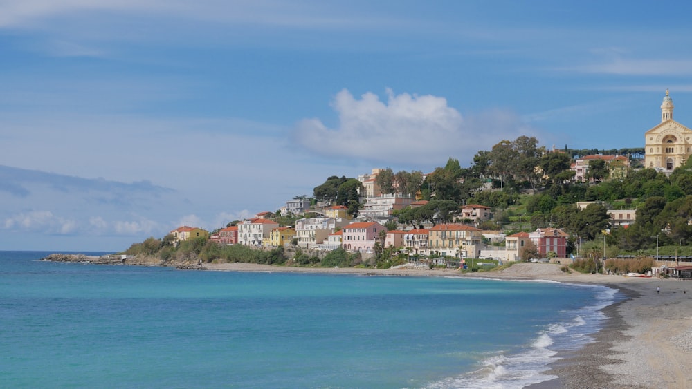 houses near sea under blue sky during daytime