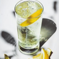 clear drinking glass with ice and lemon