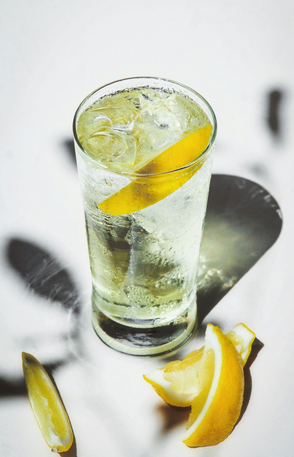 clear drinking glass with ice and lemon