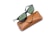 A pair of black-framed sunglasses with green-tinted lenses rests on a brown leather case. The case features a snap closure and embossed branding.