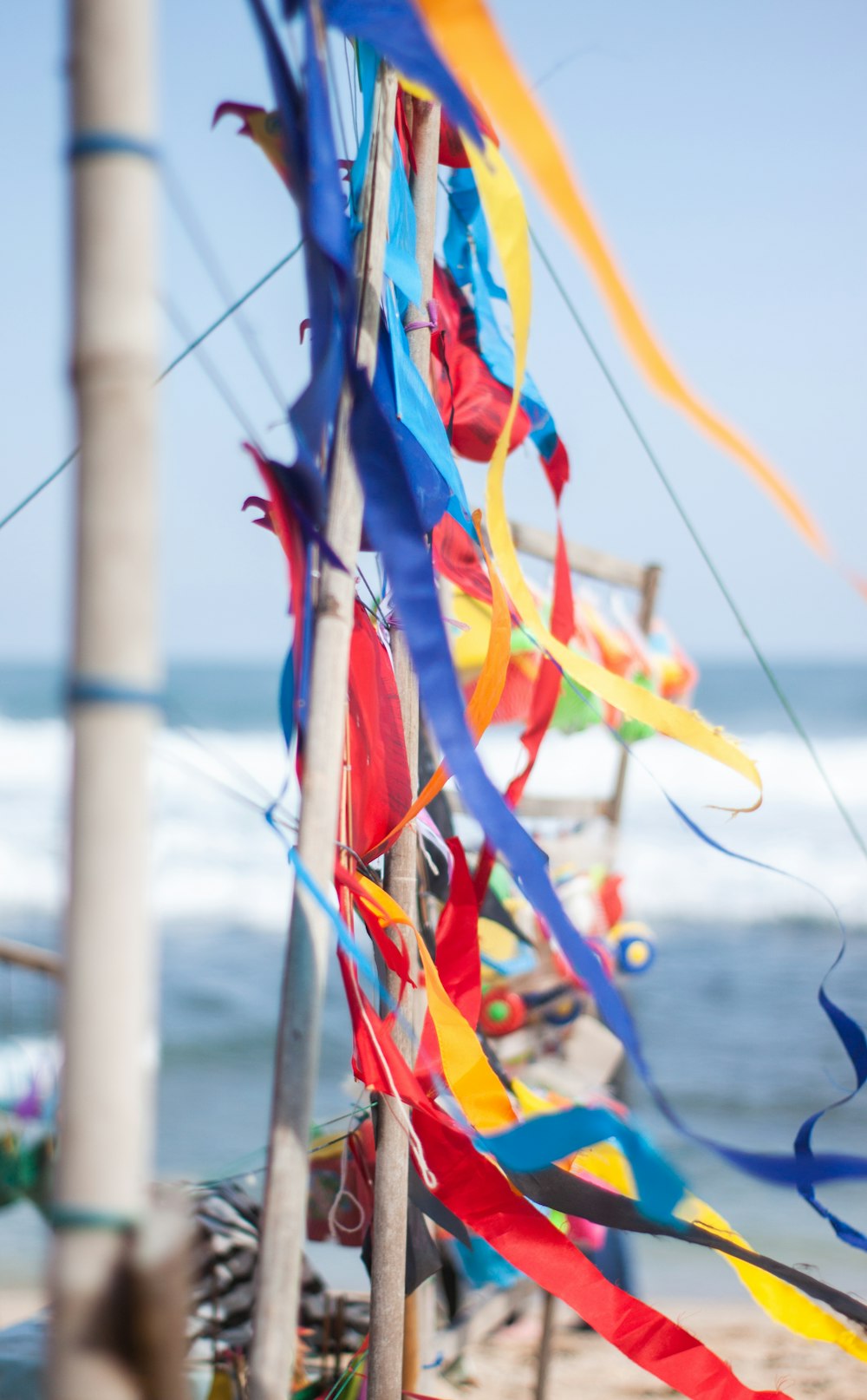 red yellow and blue ribbon on brown wooden stick during daytime