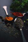brown coffee beans on silver spoon