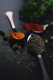 brown coffee beans on silver spoon