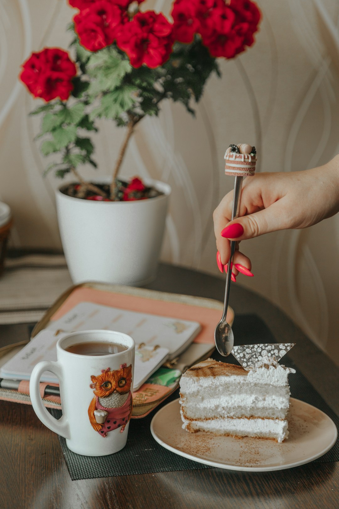 person holding silver spoon and white ceramic mug