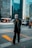 man in black and white checkered dress shirt standing on pedestrian lane during daytime