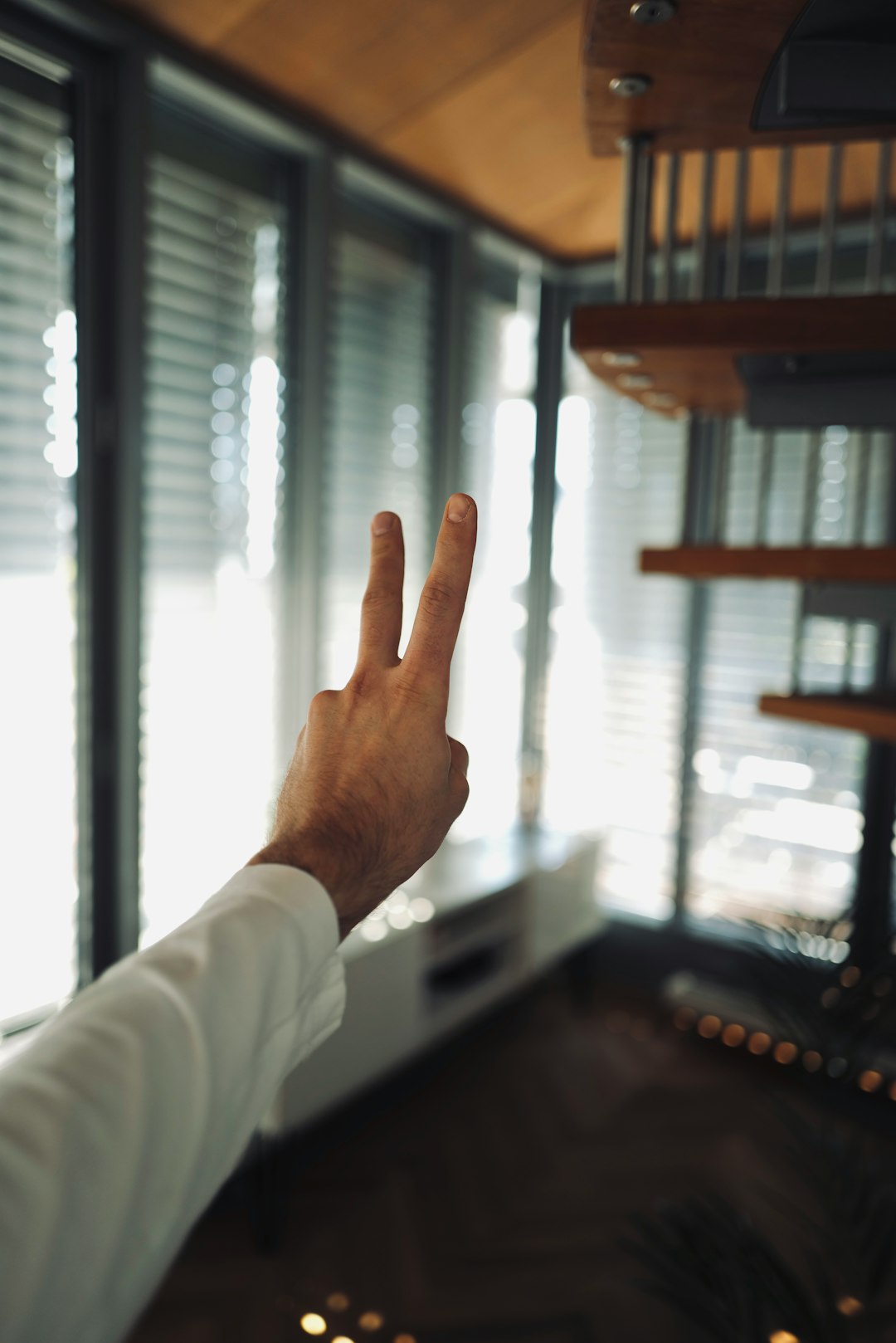 person in white long sleeve shirt showing left hand