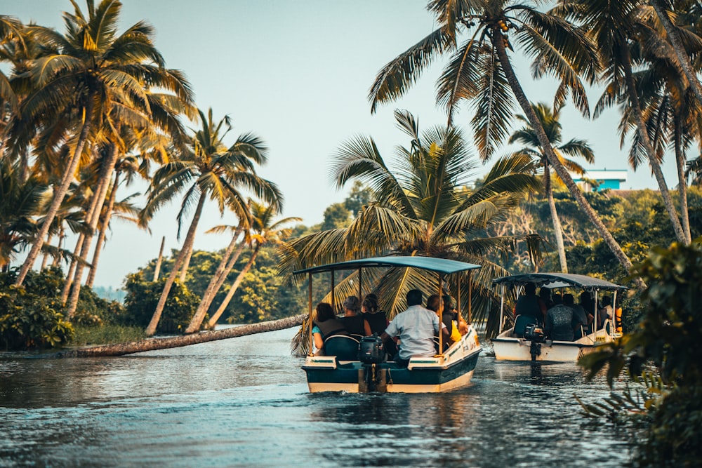 people riding on boat on body of water during daytime