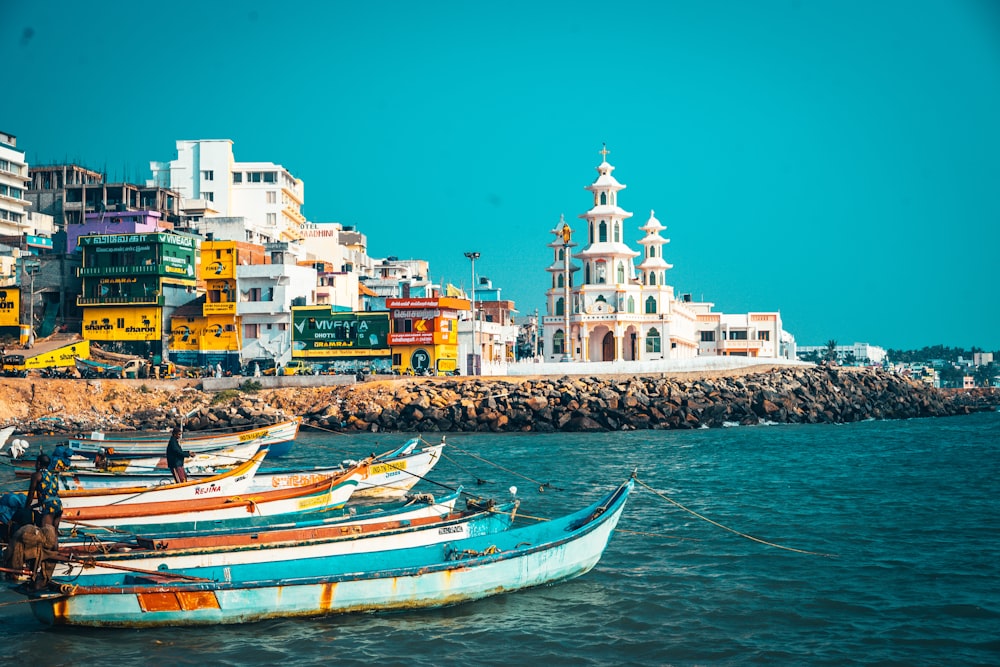 blue and white boat on sea dock during daytime