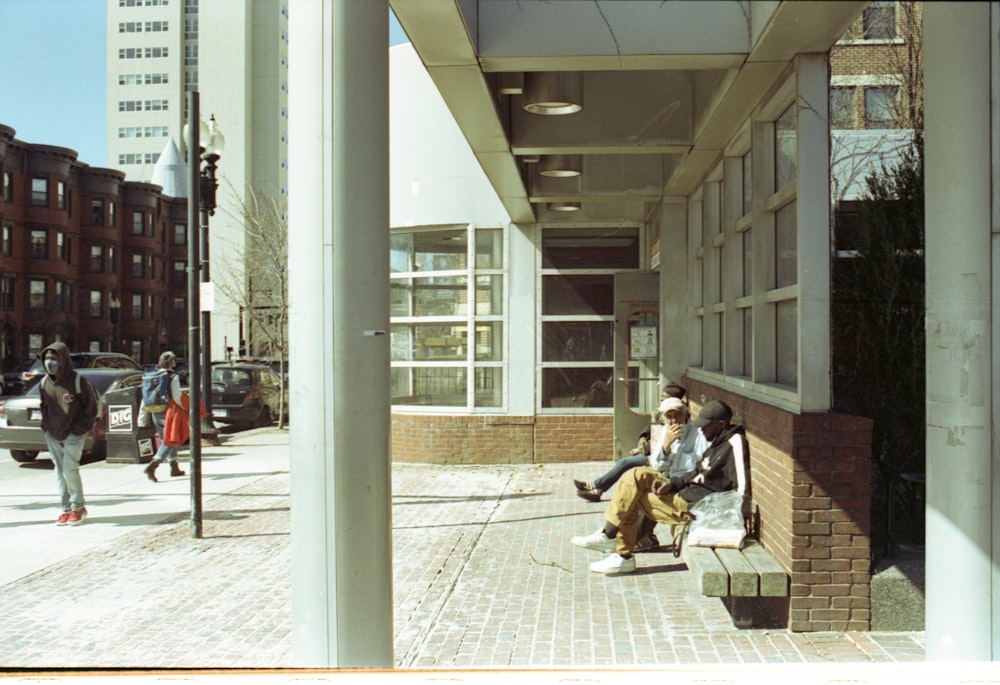 man in black jacket sitting on brown wooden bench beside woman in black jacket