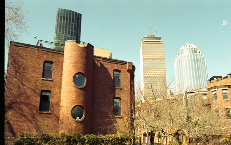A brick residential building with the Boston skyline behind it