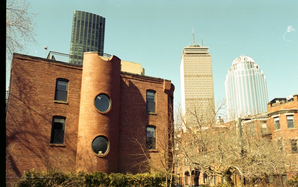 brown concrete building near green trees during daytime