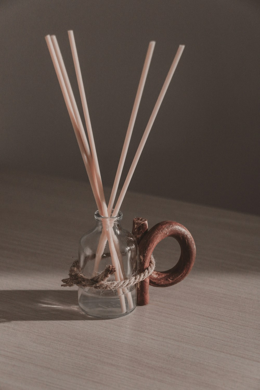 brown sticks in clear glass jar