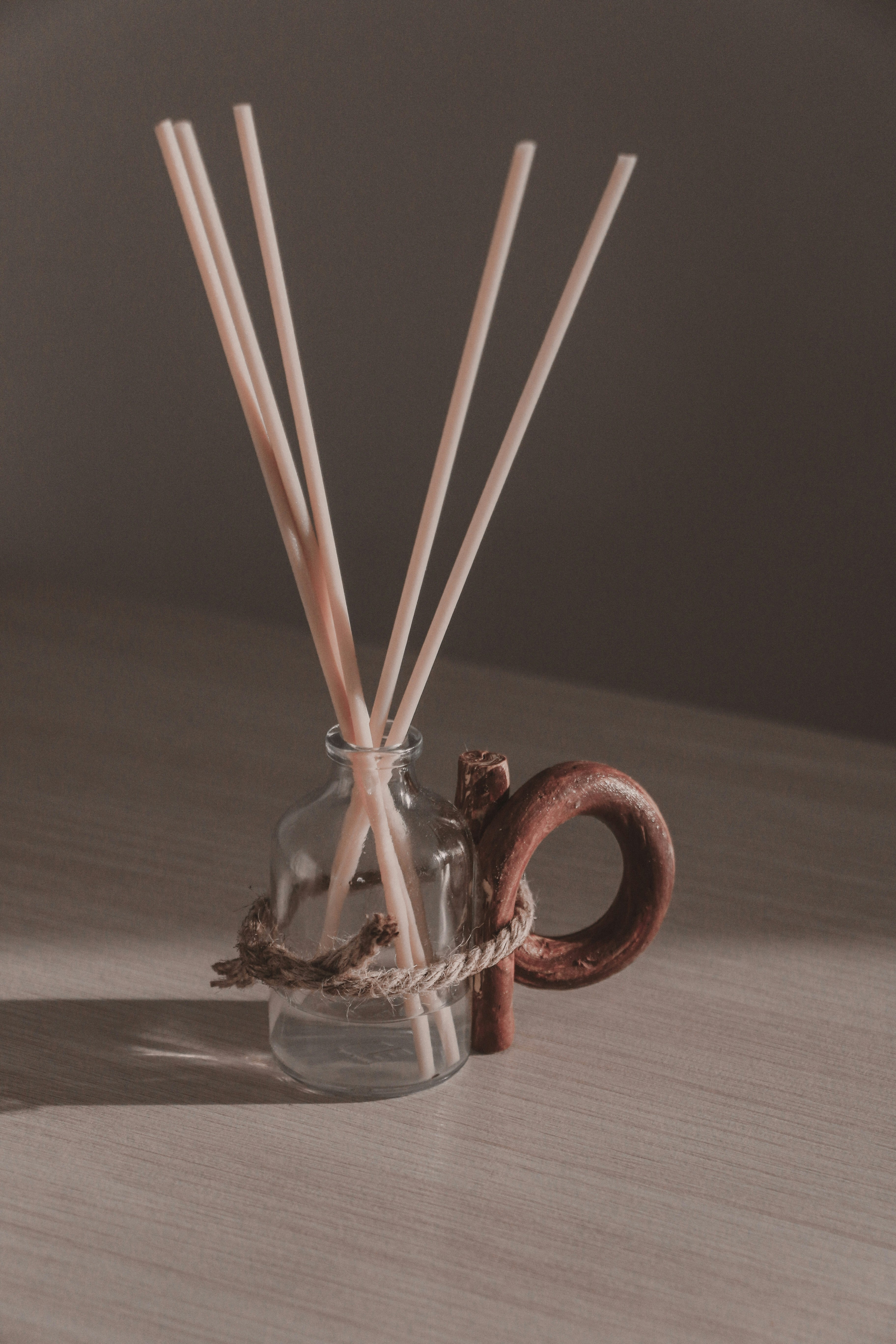 brown sticks in clear glass jar