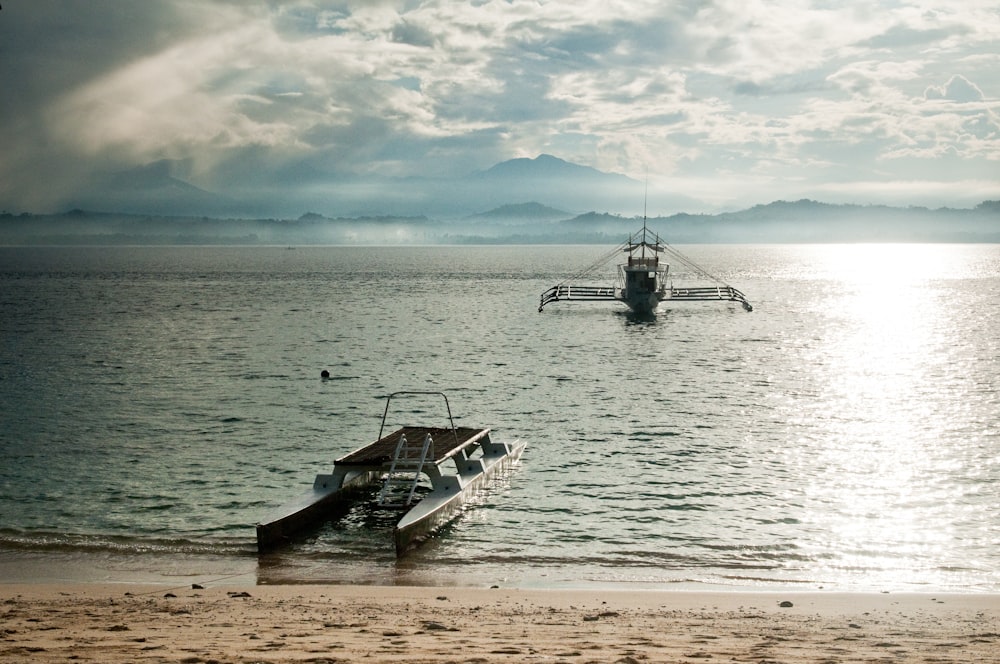 white and black boat on sea during daytime