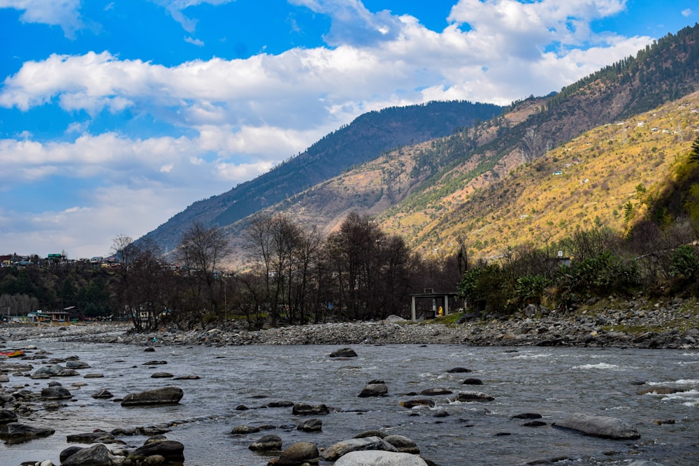 a river running through a lush green hillside