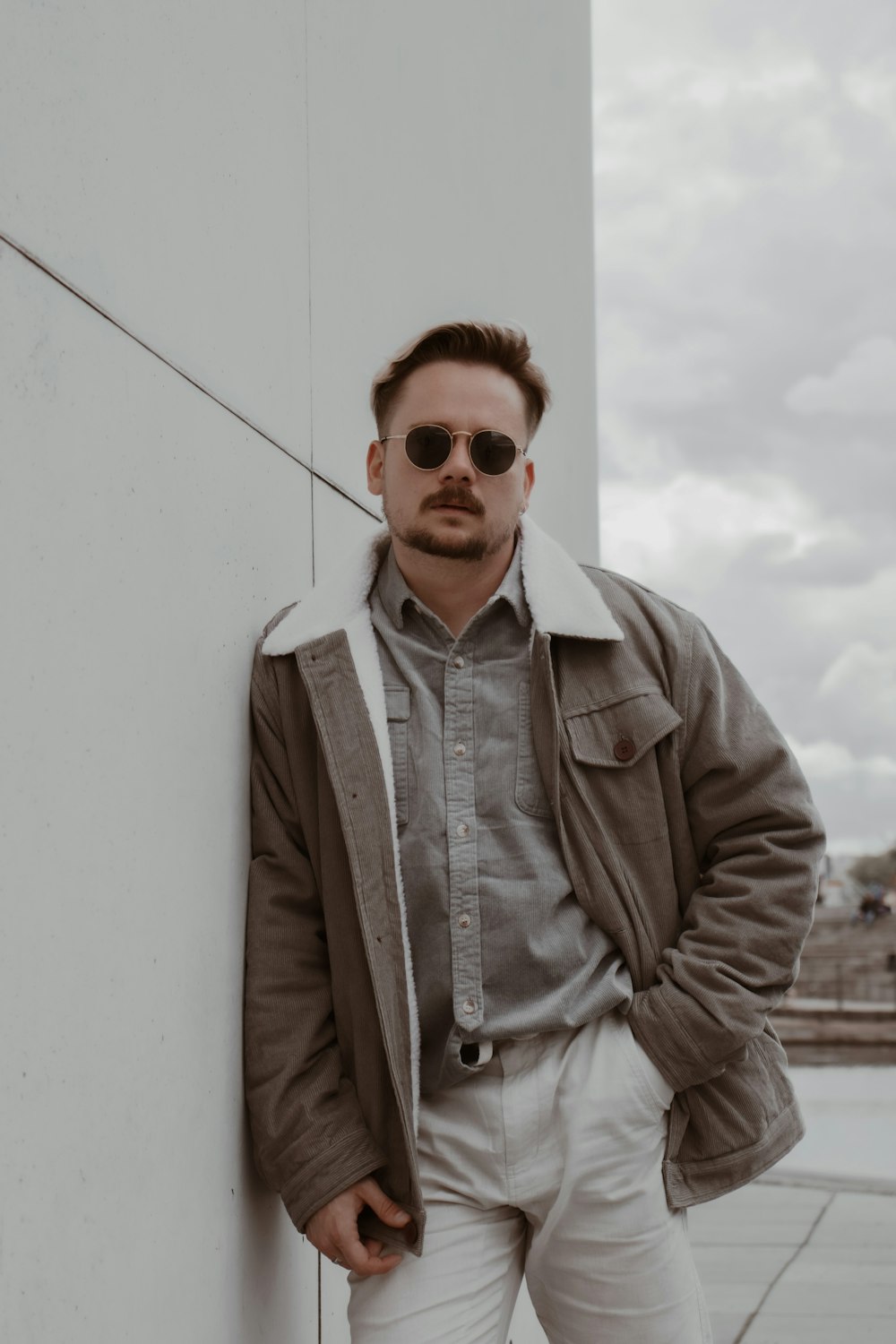 man in brown jacket wearing sunglasses