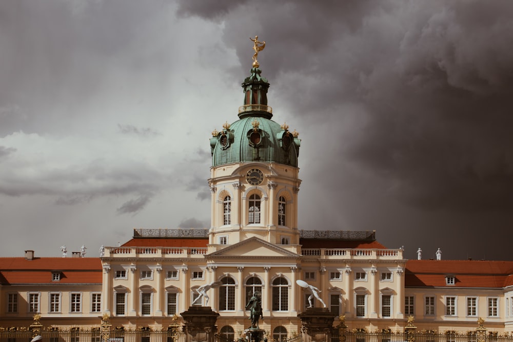 white and brown concrete building under gray clouds