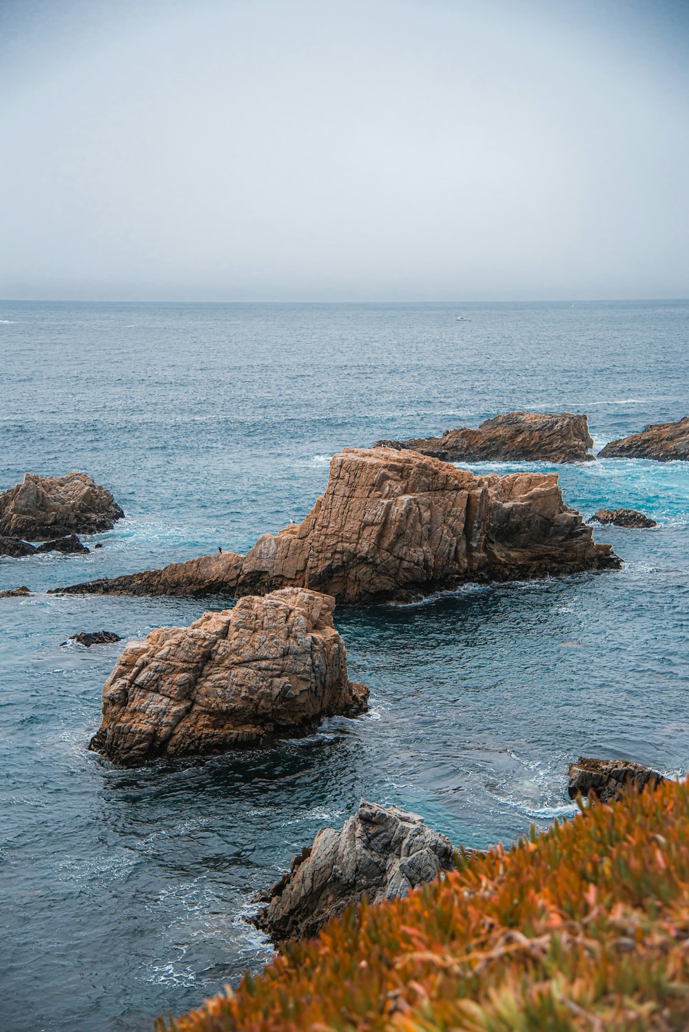 brown rock formation on sea during daytime