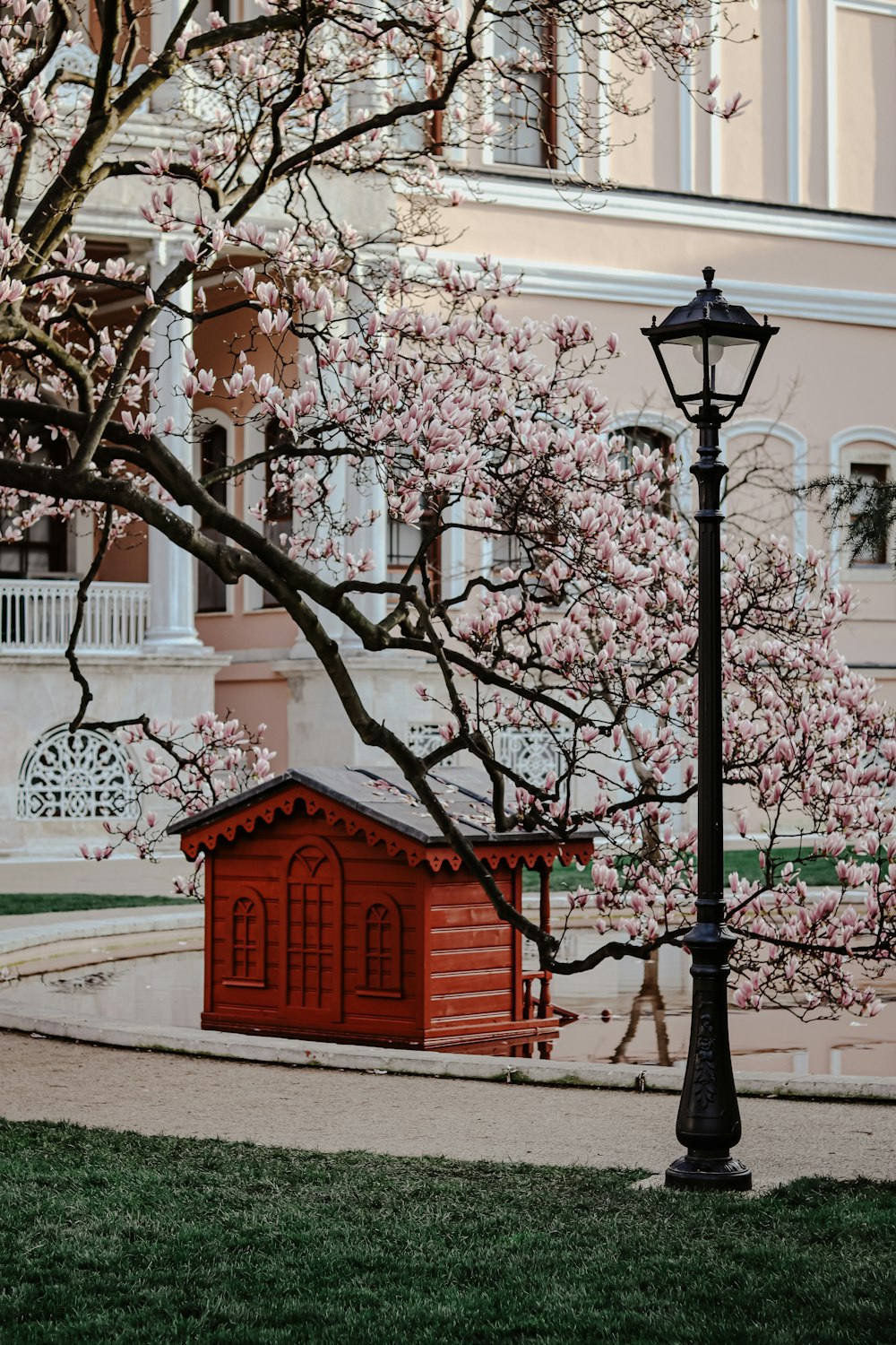 black street lamp near white and red concrete building during daytime