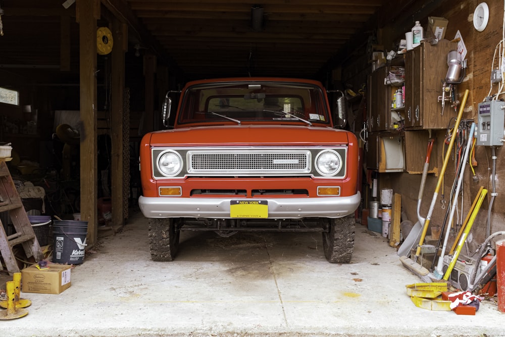 a red truck parked inside of a garage