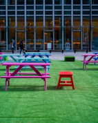 2 person sitting on bench near building during daytime