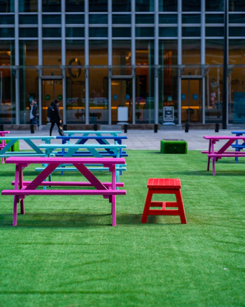 2 person sitting on bench near building during daytime