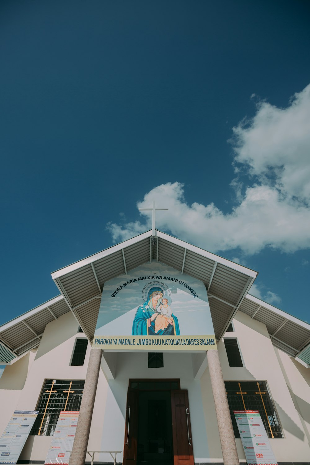 white concrete building with clock under blue sky during daytime