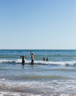 A fun day at the beach with the family playing in the waves.