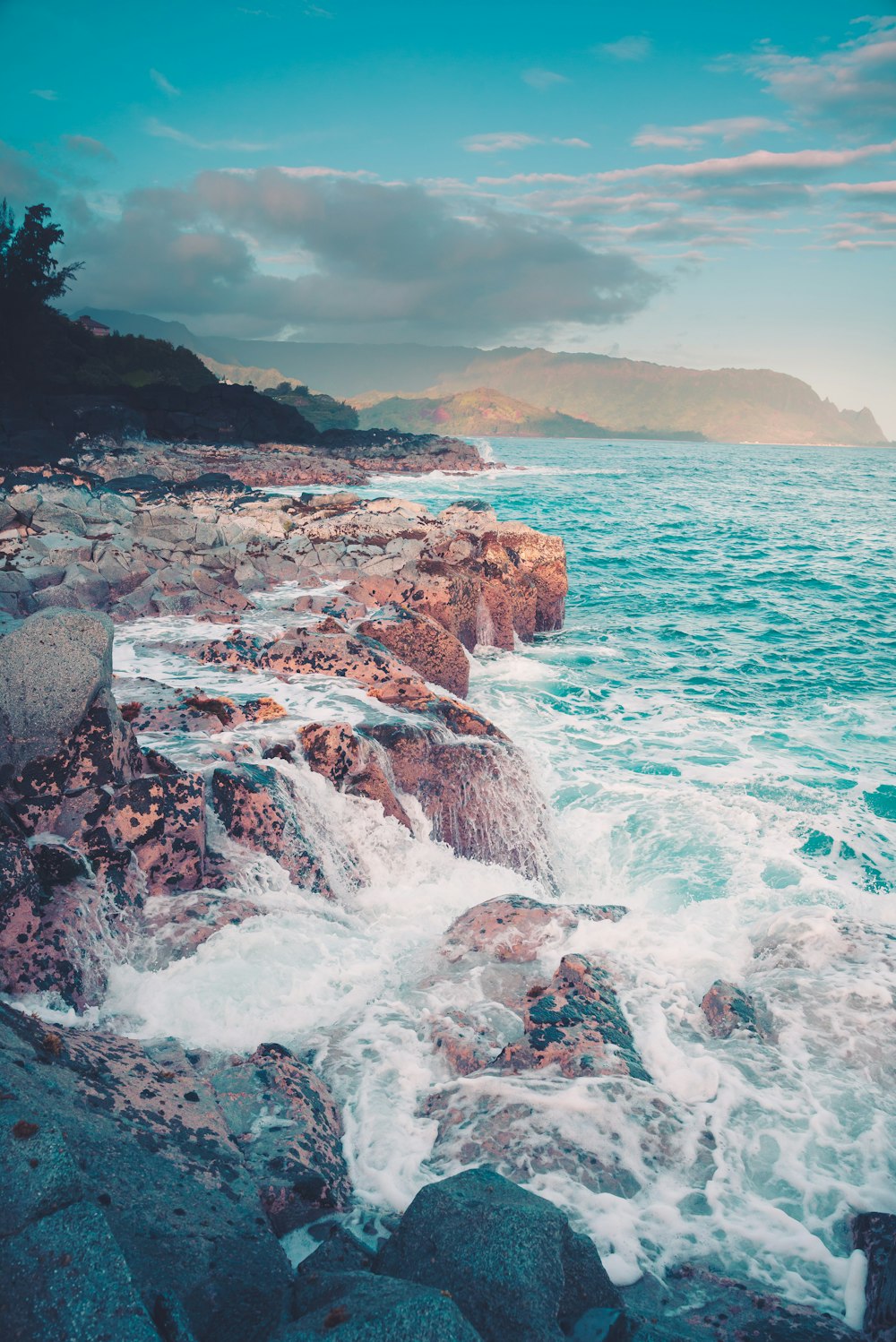 ocean waves crashing on rocky shore during daytime