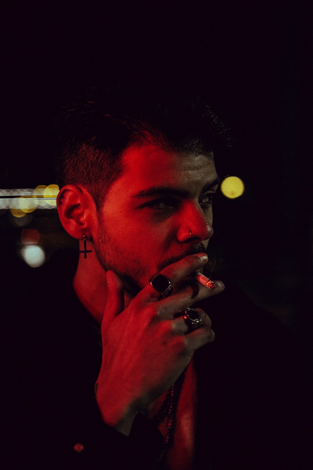 man smoking cigarette in close up photography