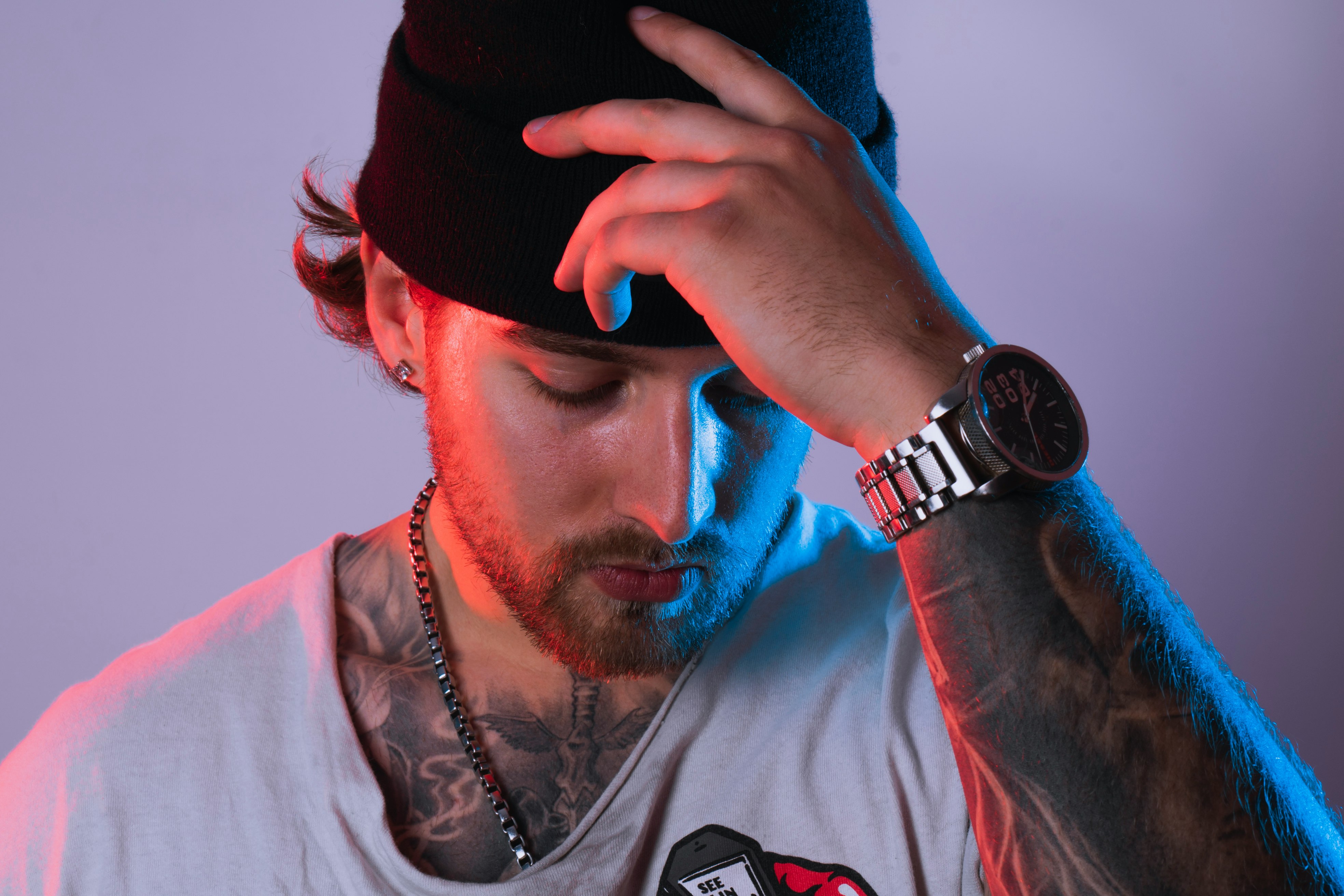 man in white shirt wearing black cap and silver watch