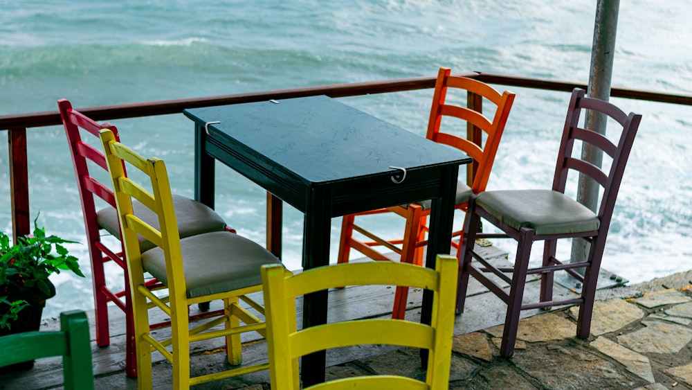 brown wooden chair beside table on beach during daytime