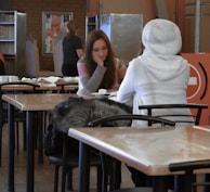 A candid moment of women sharing a meal, their faces warm with connection and understanding.