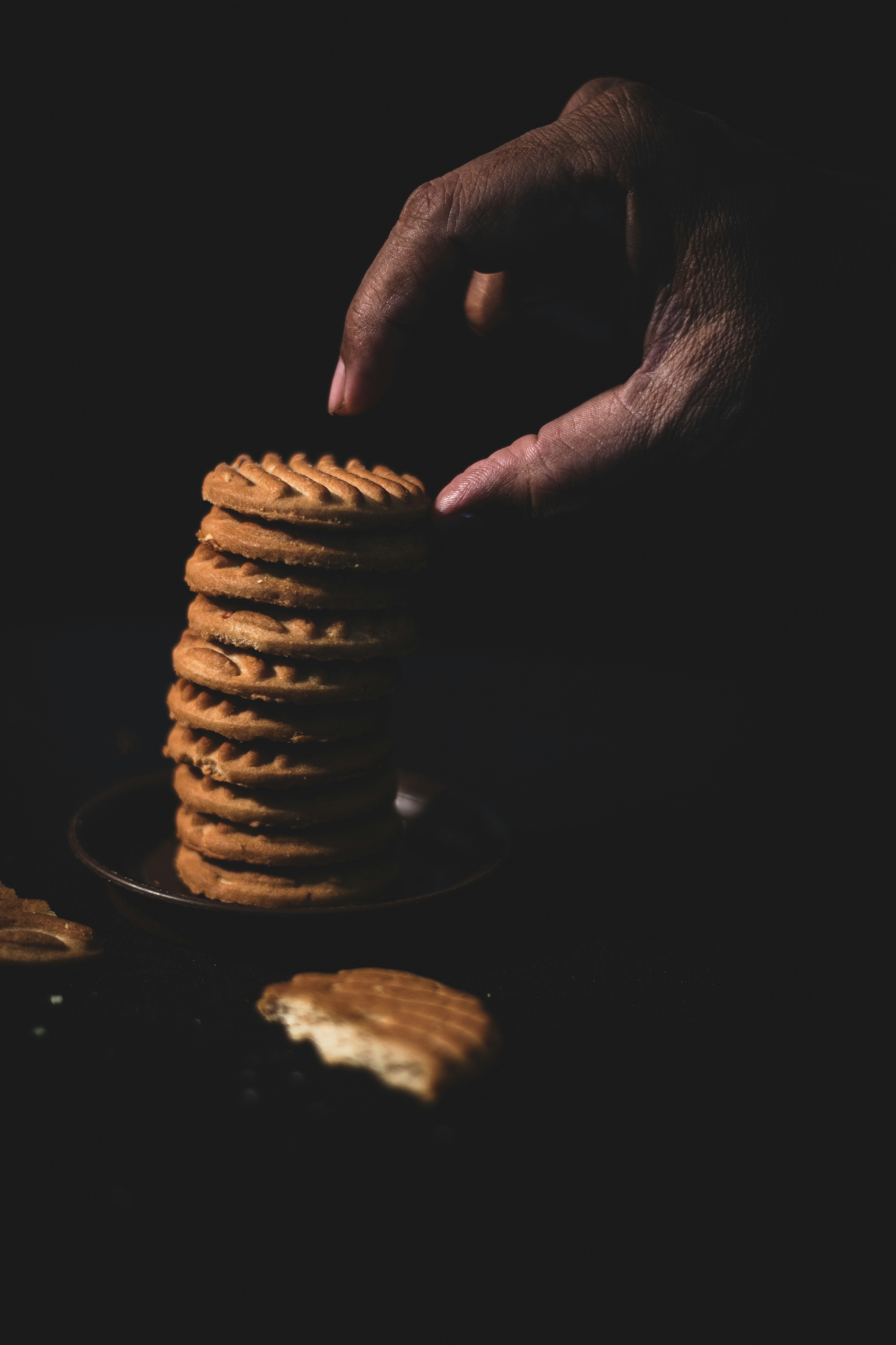 person holding pile of cookies