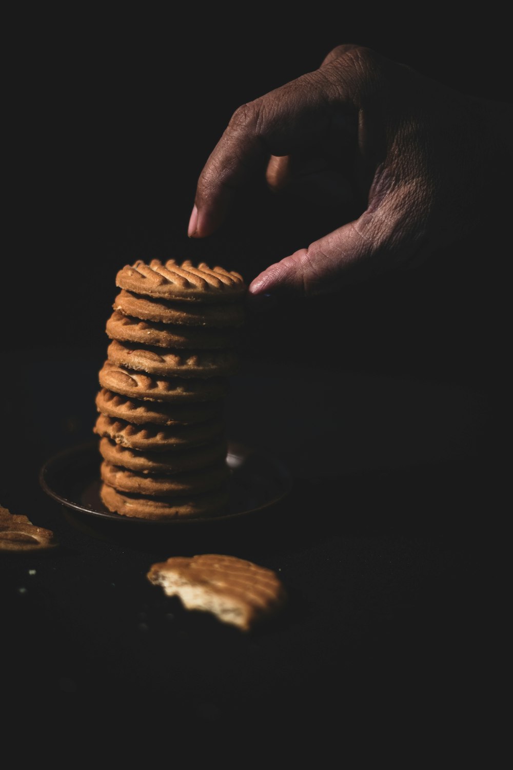 person holding pile of cookies