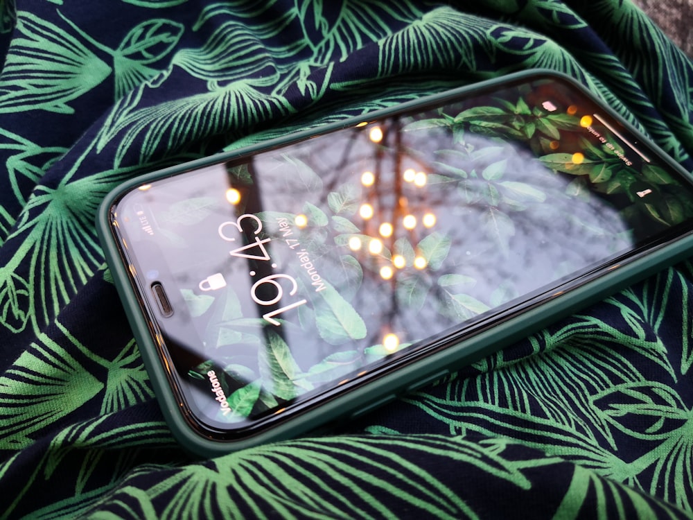 silver samsung galaxy smartphone on black and green textile