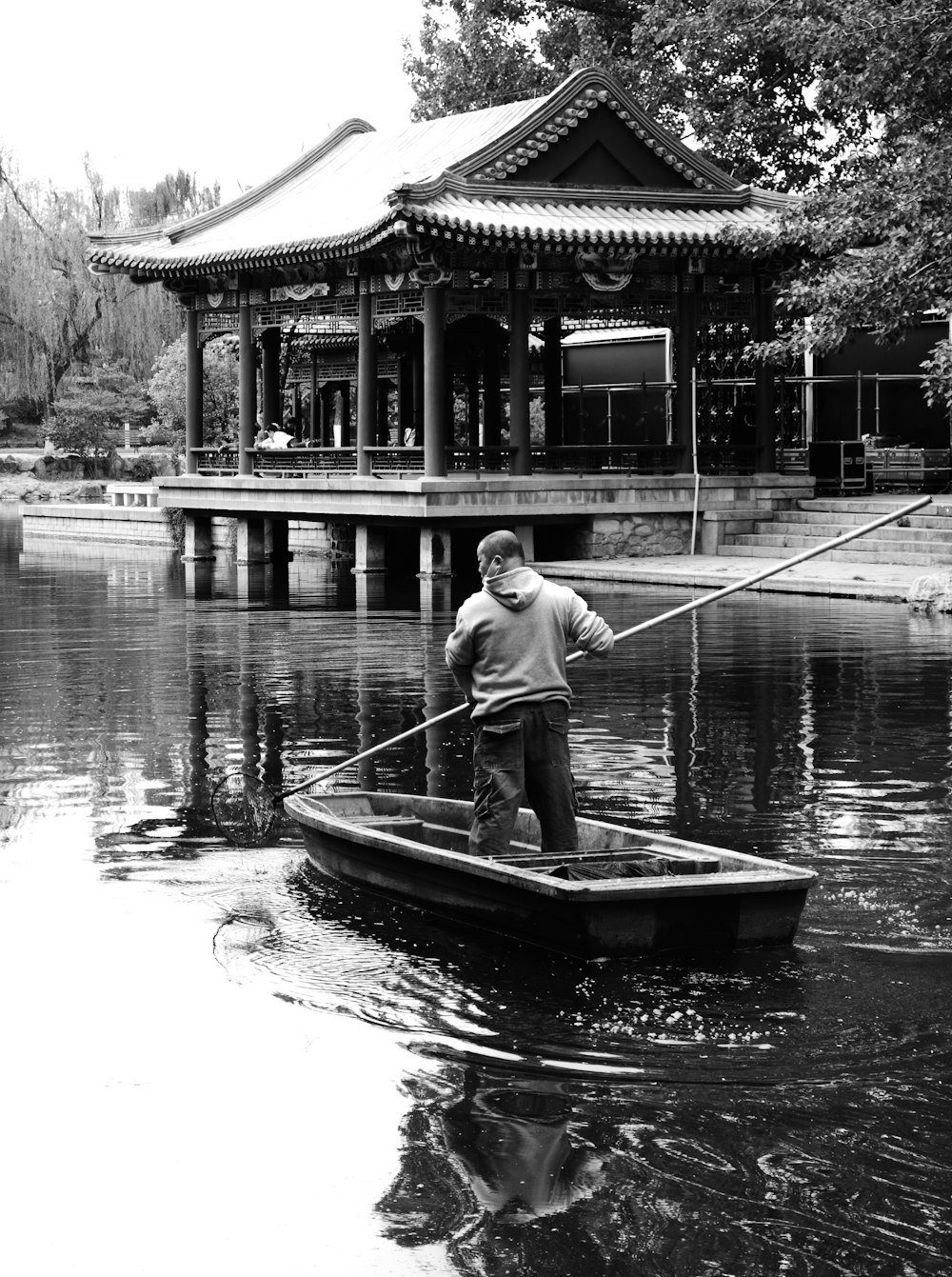 man in white shirt riding on boat on river