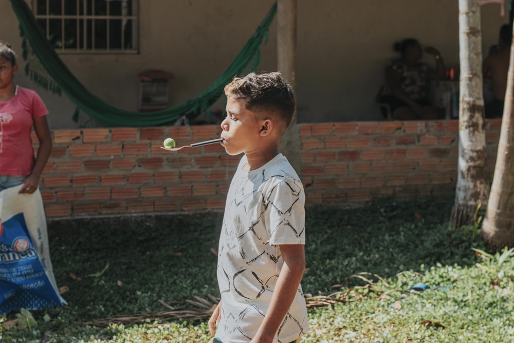 boy in white and black button up shirt playing bubbles