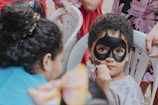 boy in white tank top with black mask