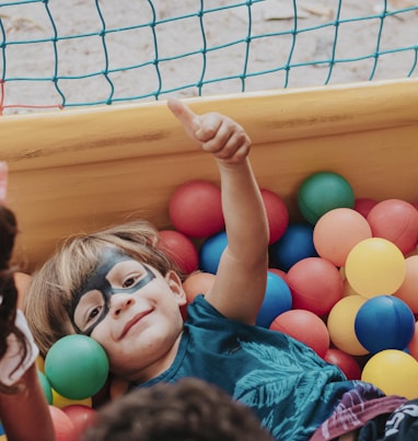 girl in blue shirt lying on yellow inflatable pool