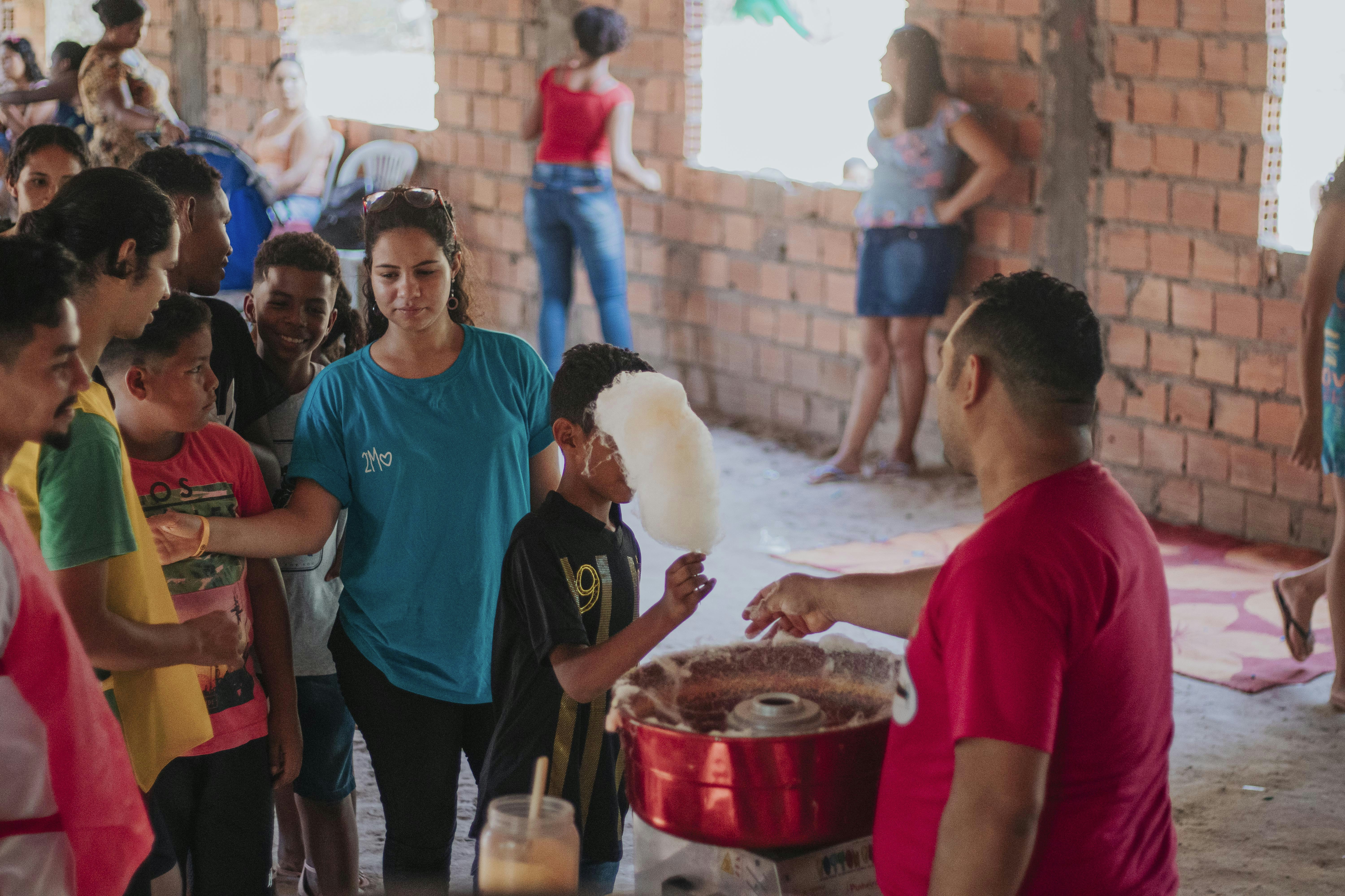 group of people standing near brown wooden table