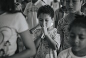 Children praying together in a bright Sunday school classroom.
