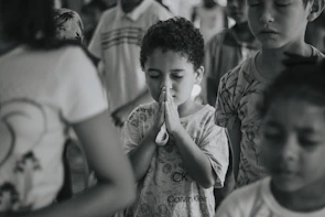 Students praying together before starting their day, hands joined in a circle.