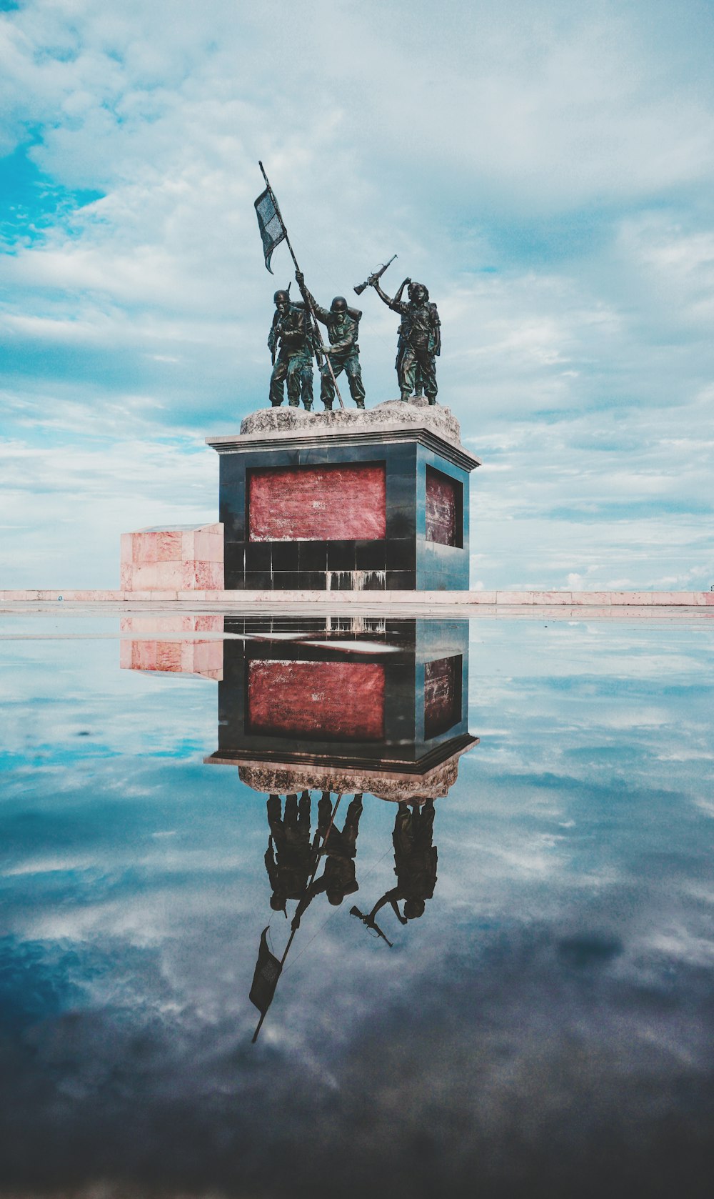 black and red wooden cross on water