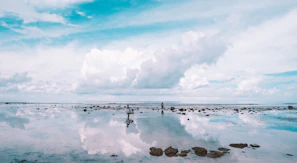 A modern interpretation of Jesus Christ walking on water with a calm sea and light sky.