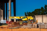 yellow and black heavy equipment near brown wooden post
