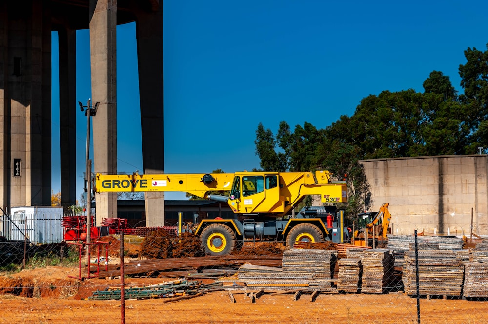 yellow and black heavy equipment near brown wooden post