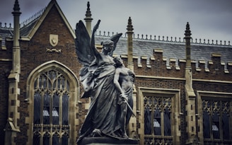 statue of a man holding a book
