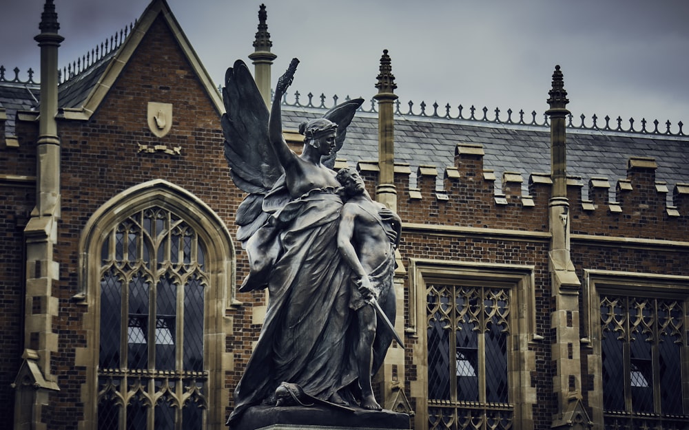 statue of a man holding a book